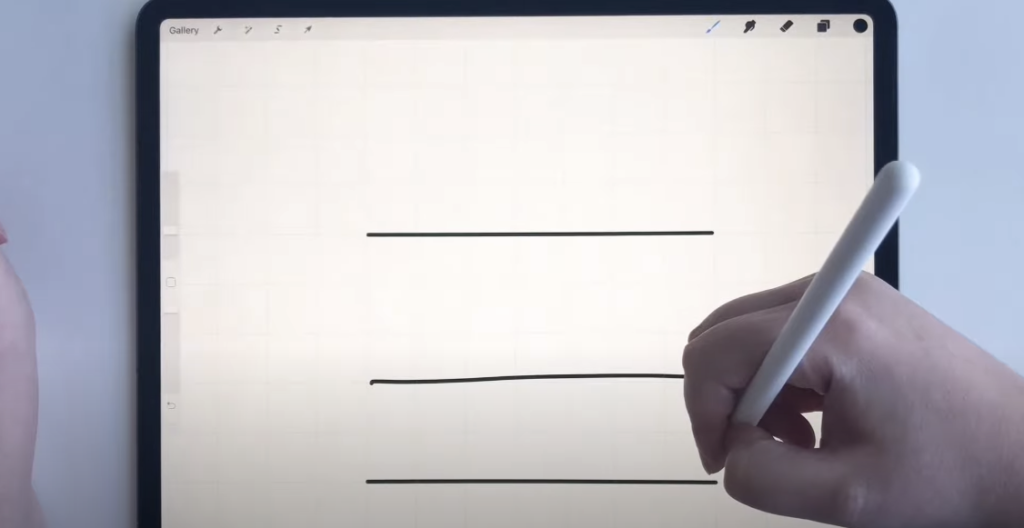 Photo of a hand using a stylus on an iPad with Procreate, showing three lines in the Procreate app. The first two lines are not straight, while the third line is perfectly straight