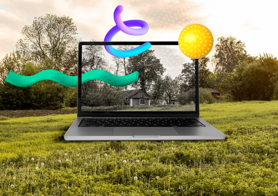 a huge 3D laptop on the grass with colorful 3D shapes around it: concept art