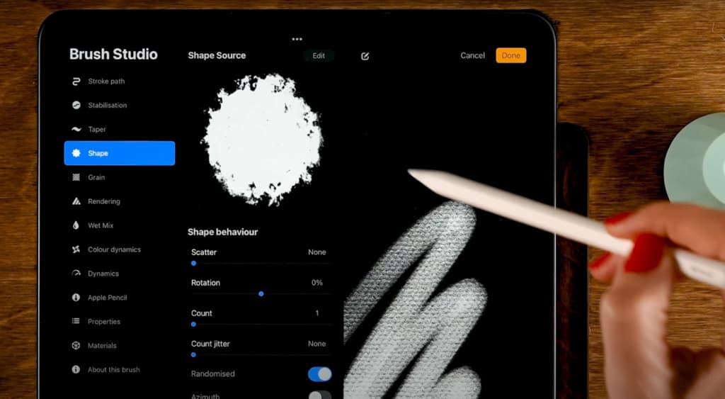 a white stylus in a hand pointing at a white 2D spot in an image-editing app